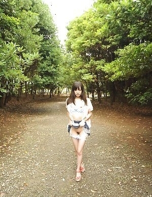 Riko Tabe shows boobs and trimmed pussy under skirt in a park.